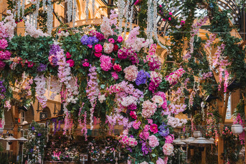 Closeup shot of flower decoration at entrance of Hays Galleria. Its concourse with boutique shops,...