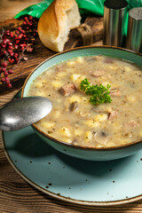 Traditional polish soup Zurek in ceramic bowl.
