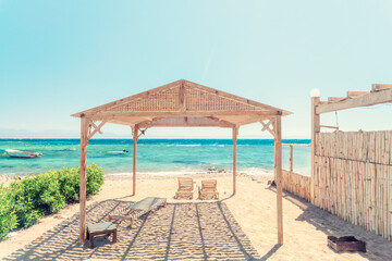 Beach with sun beds at the Red sea in Dahab Bay, Southern Sinai, Egypt