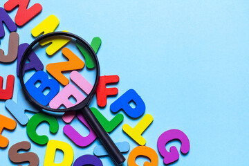 English letters scattered on blue background. Language development concept, reading, writing and...