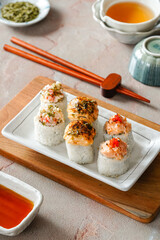 sushi is a Japanese dish of prepared vinegared rice, usually with some sugar and salt, accompanied by a variety of ingredients such as seafood, often raw and vegetables.