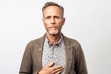 Fototapeta premium Group portrait photography of a man in his 30s clutching his chest due to gastroesophageal reflux disease wearing a chic cardigan against a white background 