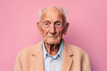 Obraz premium Headshot portrait photography of a man in his 90s with furrowed brows and a tense expression due to hypertension wearing a chic cardigan against a pastel or soft colors background 