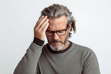 Medium shot portrait photography of a man in his 40s pressing his temple due to a migraine wearing a chic cardigan against a white background 