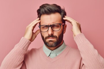 Medium shot portrait photography of a man in his 30s pressing his temple due to a migraine wearing a chic cardigan against a pastel or soft colors background 