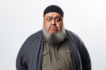 Medium shot portrait photography of a man in his 50s expressing concern about his weight due to obesity wearing hijab against a white background 