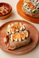 sushi is a Japanese dish of prepared vinegared rice, usually with some sugar and salt, accompanied by a variety of ingredients such as seafood, often raw and vegetables.