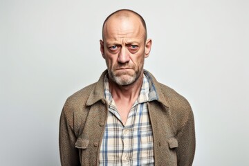 Obraz premium Medium shot portrait photography of a man in his 40s with a pained and tired expression due to fibromyalgia wearing a chic cardigan against a white background 