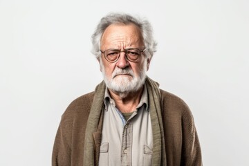 Lifestyle portrait photography of a man in his 70s with a pained and tired expression due to fibromyalgia wearing a chic cardigan against a white background 