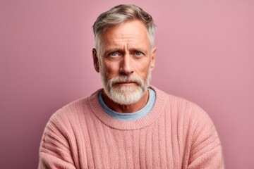 Obraz premium Medium shot portrait photography of a man in his 50s with a hint of fatigue due to chronic kidney disease wearing a cozy sweater against a pastel or soft colors background 