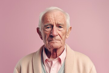 Medium shot portrait photography of a man in his 80s with a hint of fatigue due to chronic kidney disease wearing a chic cardigan against a pastel or soft colors background 