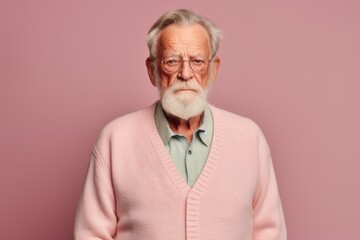 Medium shot portrait photography of a man in his 80s with a hint of fatigue due to chronic kidney disease wearing a chic cardigan against a pastel or soft colors background 