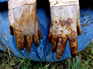 protective gloves of a worker after a chemical accident. corroded and dirty with lye and unknown...
