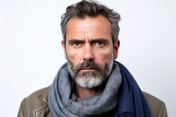 Medium shot portrait photography of a man in his 40s showing tiredness and a worn-down expression due to chronic fatigue syndrome wearing a charming scarf against a white background 