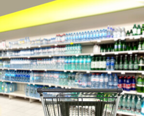 choosing a dairy products at supermarket.empty grocery cart in an empty supermarket