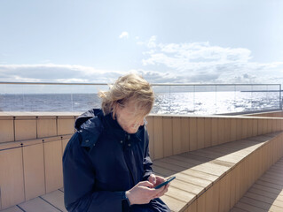 Lifestyle portrait of a young man using a smart phone outdoors.