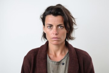 Medium shot portrait photography of a woman in her 30s with a somber and deeply sad expression due to major depression wearing a chic cardigan against a white background 