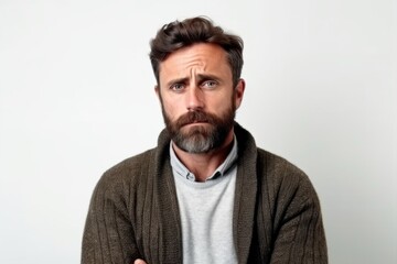 Obraz premium Medium shot portrait photography of a man in his 30s with a somber and deeply sad expression due to major depression wearing a chic cardigan against a white background 