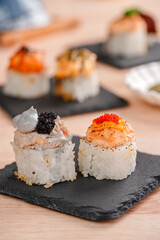 sushi is a Japanese dish of prepared vinegared rice, usually with some sugar and salt, accompanied by a variety of ingredients such as seafood, often raw and vegetables.