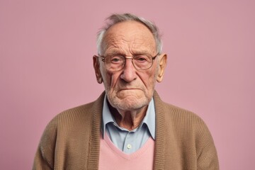Obraz premium Group portrait photography of a man in his 80s with a somber and deeply sad expression due to major depression wearing a chic cardigan against a pastel or soft colors background 