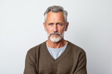 Obraz premium Medium shot portrait photography of a man in his 50s looking anxious and fidgety due to generalized anxiety disorder wearing a chic cardigan against a white background 