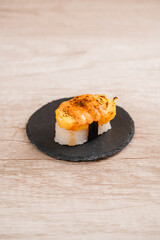 sushi is a Japanese dish of prepared vinegared rice, usually with some sugar and salt, accompanied by a variety of ingredients such as seafood, often raw and vegetables.