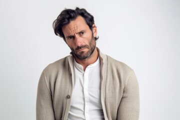 Fototapeta premium Medium shot portrait photography of a man in his 30s visibly in discomfort and fatigue from an autoimmune disease like lupus wearing a chic cardigan against a white background 