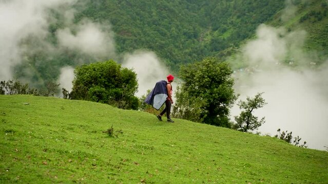 Man hiker enjoying walk by the Mountain. Man hiking alone on vacation. Summer mountain coastal landscape Uttarakhand, india.