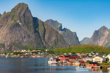 Fototapeten The most famous fishing village Reine with traditional red fisherman's cabins on Lofoten islands, Nordland, Norway. Amazing nature with dramatic mountains and peaks, open sea, pier and bay © Lizaveta