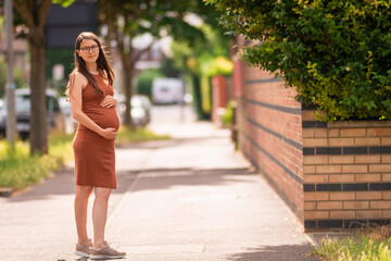 Beautiful young pregnant woman belly london smiling confident  city street outdoors walk urban...