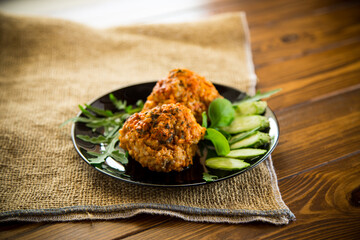 Cooked meatballs in a plate with fresh vegetables