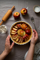 Cooking apple pie pastry. Raw pie with red apples in baking tin