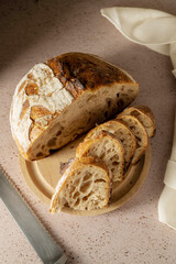 Sourdough homemade bread made from high protein white flour, cut into slices on cutting board.Top view.