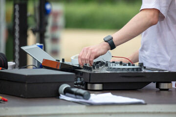 DJ with mixing console in nature.
