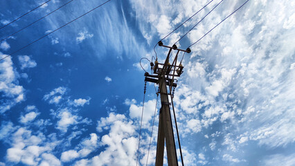 Closeup of old power poles on a clear summer day. Old hight voltage electric pole with wires and...