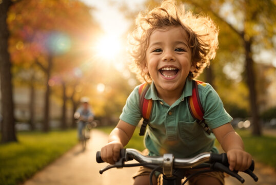 happy joyful child riding a bicycle in the park on nature.

