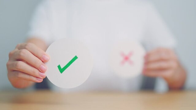 Woman show Right symbol paper. True and false, accept and rejected, evaluation, Vote, Poll, Yes or No and Survey concepts