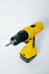 Black and yellow cordless drill on a white isolated background.