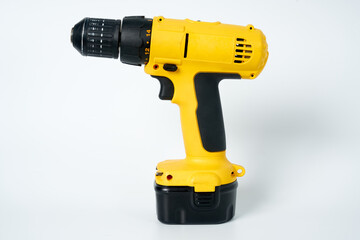 Black and yellow cordless drill on a white isolated background.