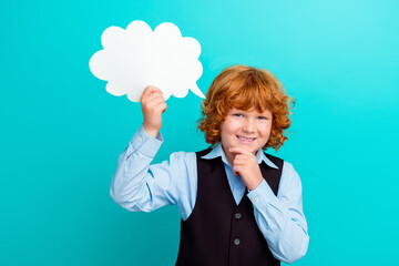 Photo of creative smart small schoolkid hand touch chin hold empty space cloud shape bubble card isolated on teal color background