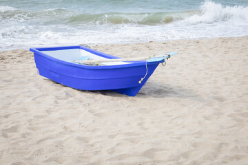 Blue rowing boat on the beach