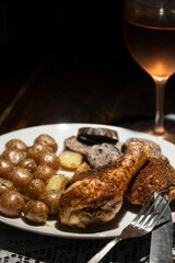 Seasoned crispy baked chicken dinner with wine.