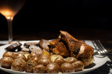 Seasoned crispy baked chicken dinner with wine.