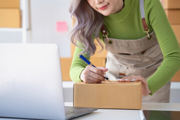 SME Small Business Entrepreneur, Asian Young Woman Smiling Fresh Face Preparing Orders for Customers Packing Delivery Boxes, Work From Home Online, E-commerce.