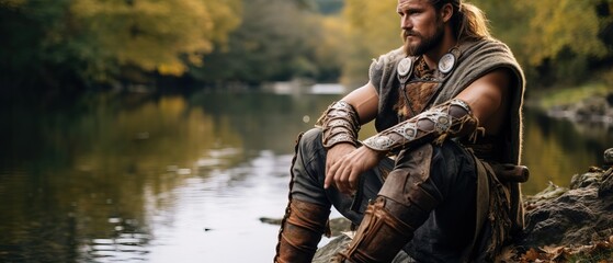 Obraz premium A Big Viking Resting near a Lake after Fighting.