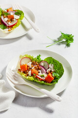 healthy sweet potato lettuce boats with radish, feta cheese, lentils