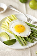 Boiled asparagus with fried egg and black pepper. Healthy breakfast