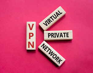 VPN - Virtual Private Network. Wooden cubes with word VPN. Beautiful red background. Business and VPN concept. Copy space.