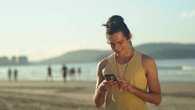 relaxed caucasian man hold use smart phone watching social media at the beach 
