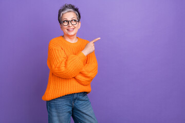 Photo of elderly workaholic business woman wear orange pullover directing finger look mockup...